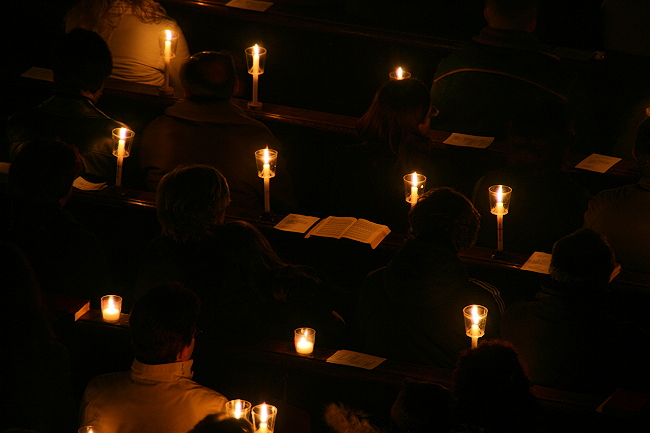 church-goers and candles as light source